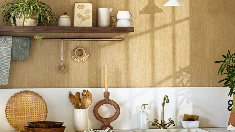 A modern kitchen with textured wallpaper.