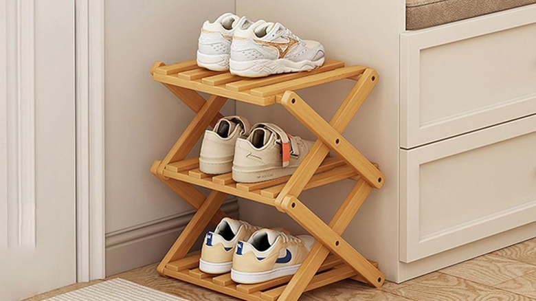 A three tier wooden shoe rack.