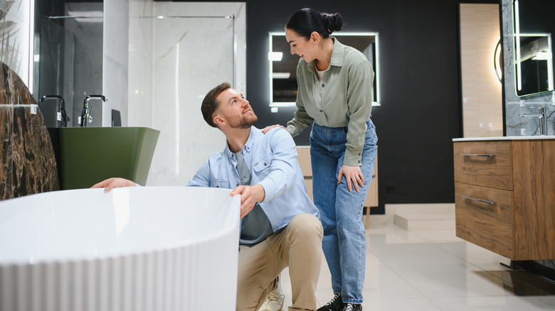 Young couple shopping for a new bathtub in a store