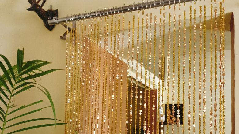 An open doorway with gold beaded curtain