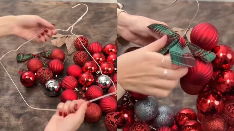 A person making a wreath out of a hanger and ornaments