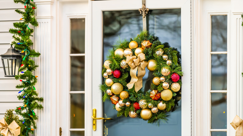 Front door decorated with an ornament wreath