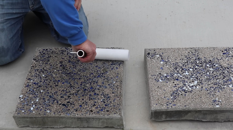 A square stepping stone made from cement and ground glass.