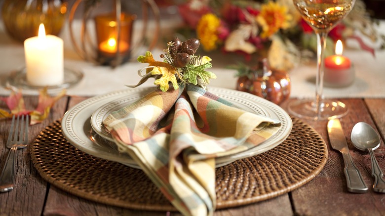 Rustic Thanksgiving table setting with napkin on plates