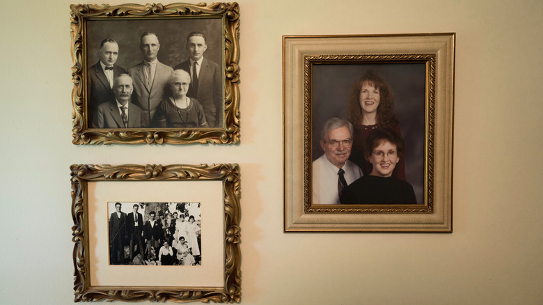 A family photo wall with photos spanning several generations
