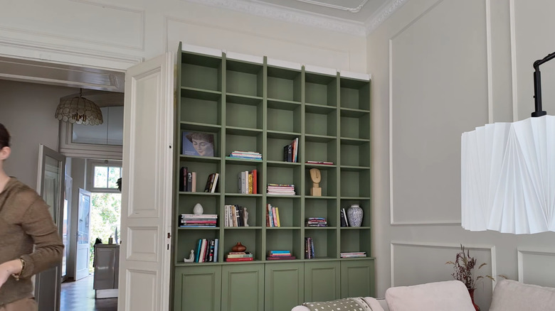 painted green bookshelf in white room