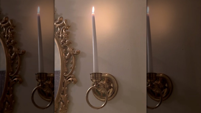 vintage candle stick and towel holder in a bathroom