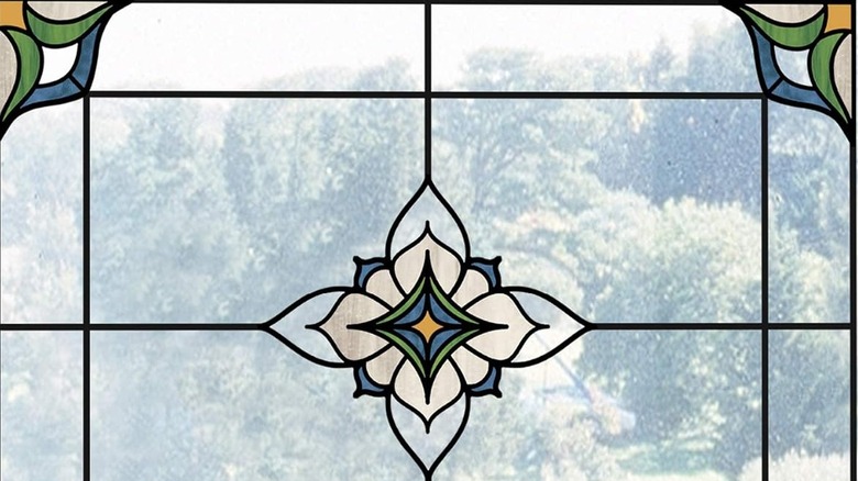 A close-up of a window with a stained-glass decal.