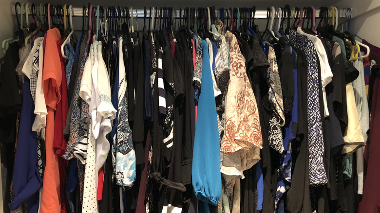 Clothes hanging in small wardrobe