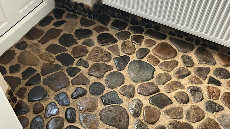 Beach pebble flooring in entryway