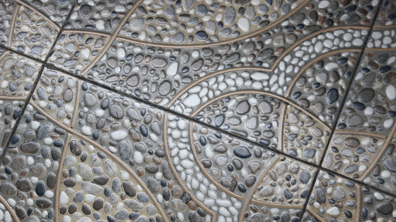 Pebble tiled flooring with intricate design