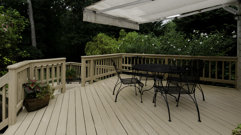 Deck with black furniture and white overhang