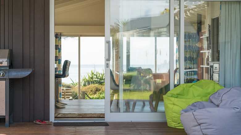 The entrance to a home with an open sliding glass door