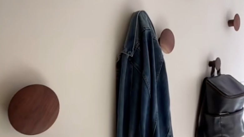 large round wooden knobs on wall as wall hooks