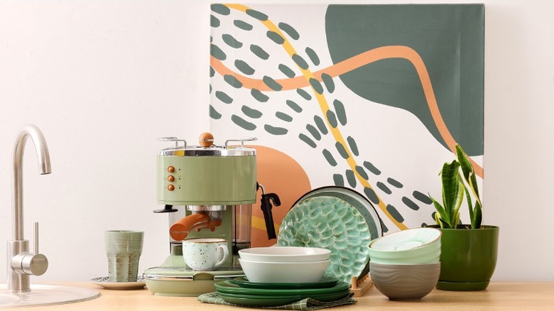 modern canvas behind coffee machine and plates on kitchen counter