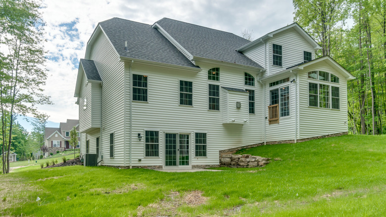 big house with a sloped backyard