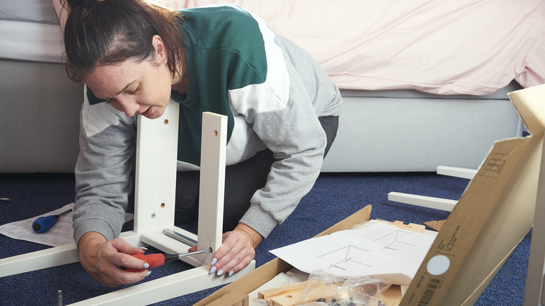 woman assembling furniture