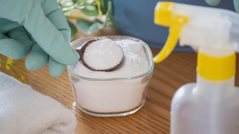 scooping tablespoon of baking soda