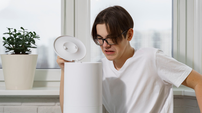 Man opening a dirty humidifier