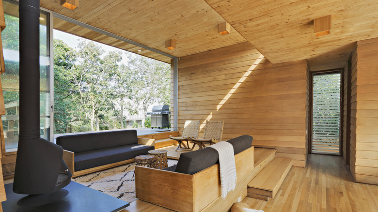 home featuring wood panel walls and ceiling