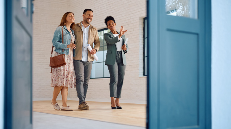 realtor showing home to couple