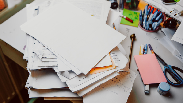 Pile of paper clutter on table
