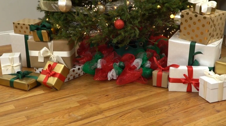 Christmas tree with ribbon wreath tree skirt and wrapped gifts