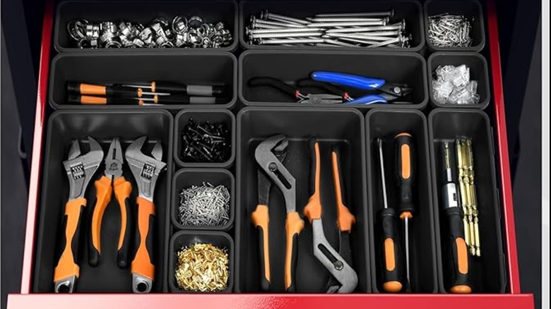 An open tool box with multiple tray organizers inside.