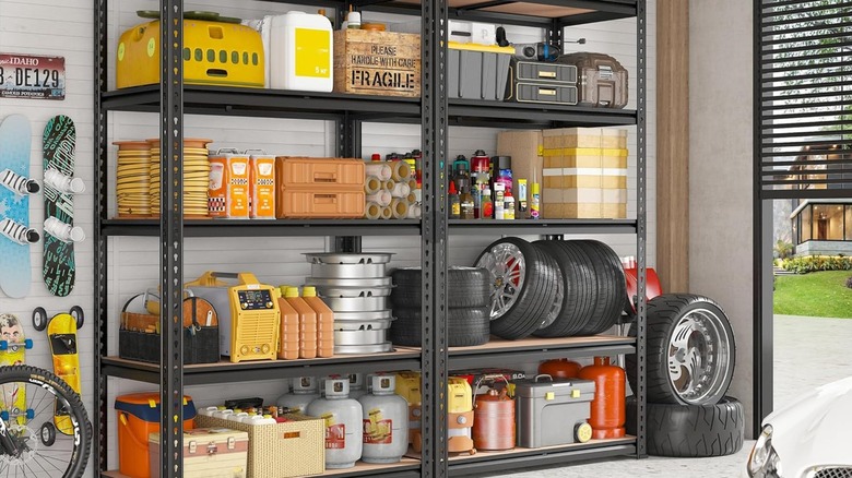 Two metal shelves holding garage and car items.