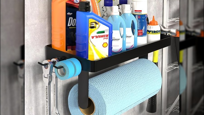 Paper towel organizer with supplies on wall.