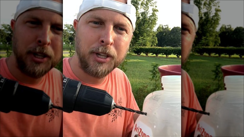 Person drilling holes in milk jugs