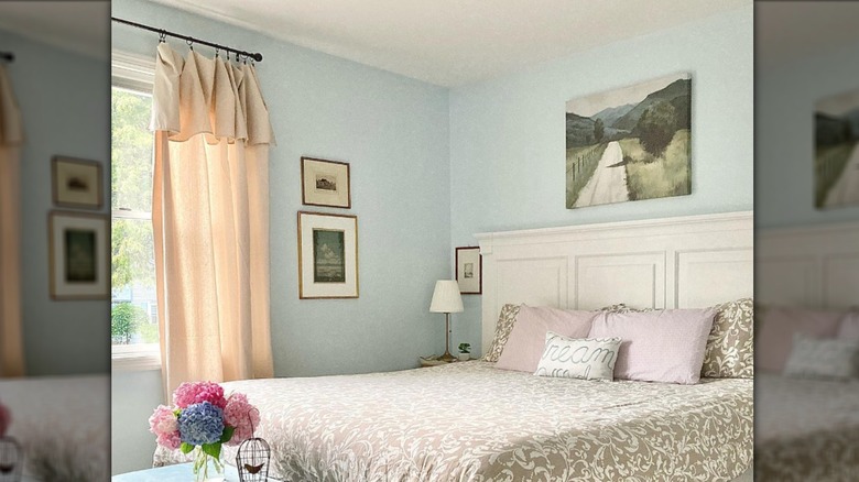 Bedroom with drop cloth curtains on window