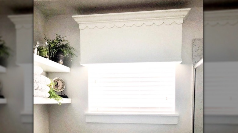 Wooden valance with scalloped edge installed over window
