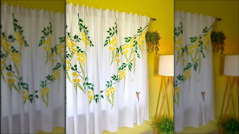 White curtains with painted yellow flowers and green leaves