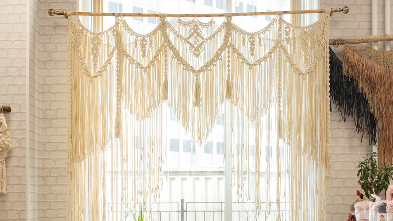 Macrame curtain hanging in front of a window