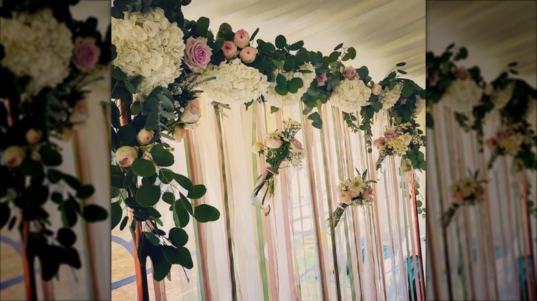 Ribbon curtains with floral valance in window