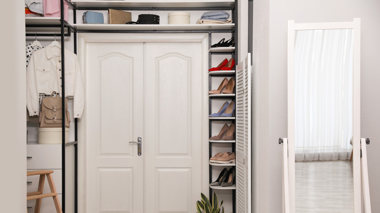 Shelves over a door holding handbags