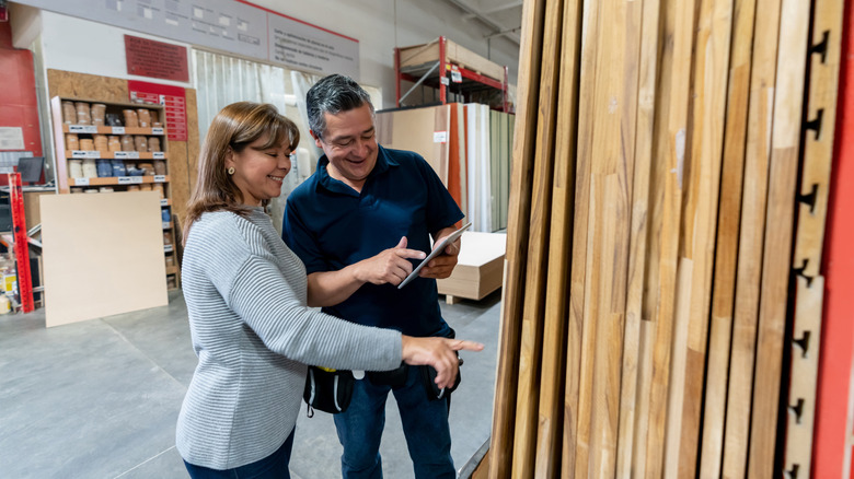Woman and man shopping in warehouse for wood butcher block material.