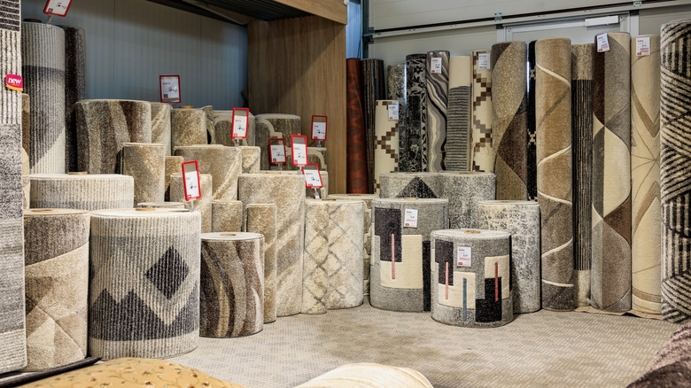 A collection of traditional rugs for sale in a store