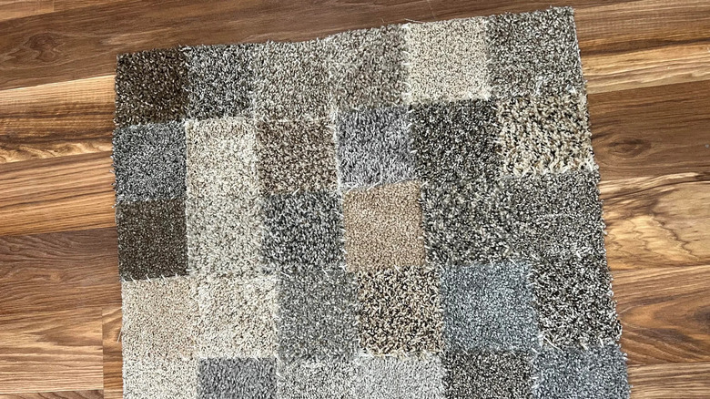 a patchwork of carpet samples sewed into one larger rug