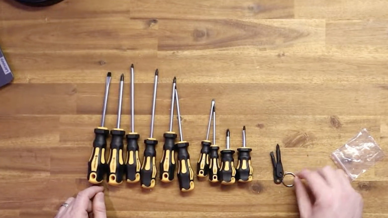 A 10 piece yellow and black screwdriver set on a table