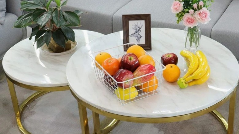Basket filled with fruit sitting on a marble top living room table