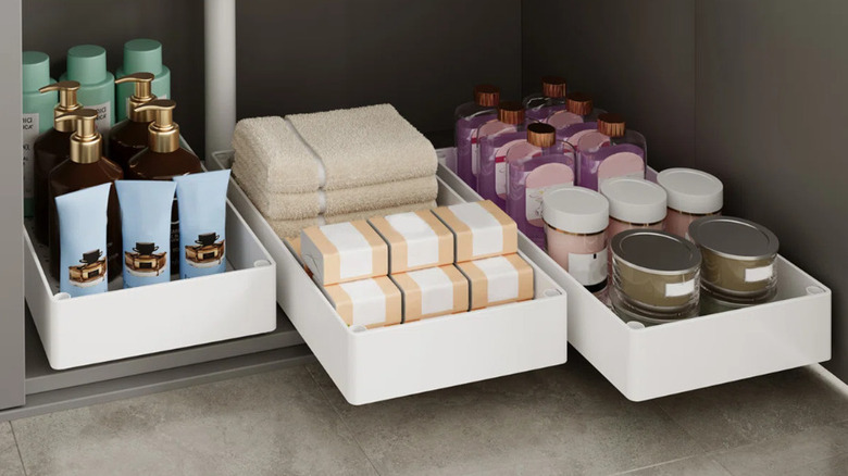 Three under the cabinet rolling drawers filled with toiletries