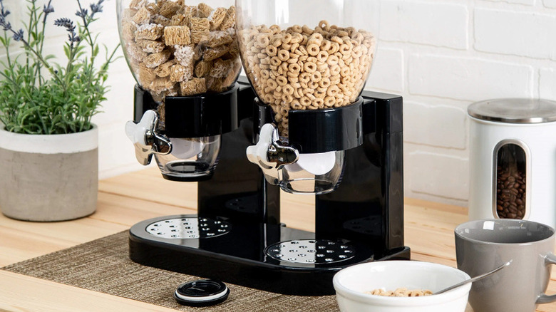 Three empty food dispensers sitting on a kitchen counter