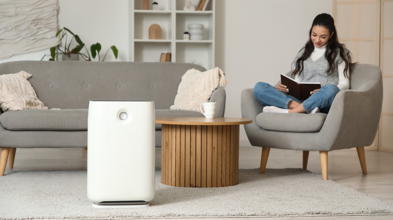 A smiling woman sitting in a chair in her living room