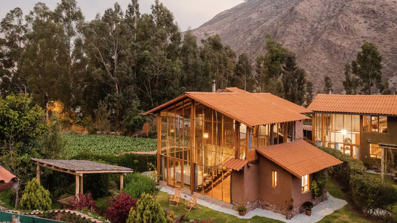 A cabin surrounded by trees and mountains