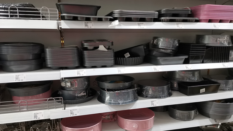 A collection of baking dishes for sale on shelves