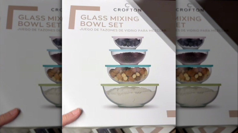 A hand holding a box of Aldi Crofton glass mixing bowls