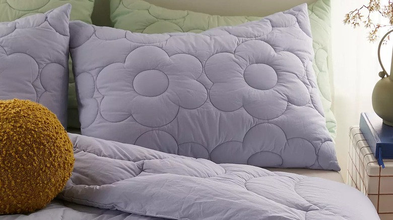 Urban Outfitters Daisy Puff Lavender Quilt on bed and pillows