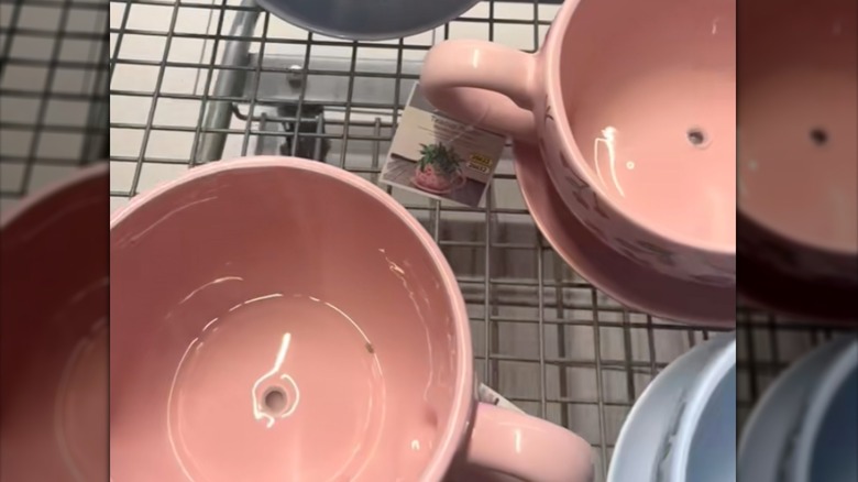 Pink Aldi teacup planters in cart showing drainage hole